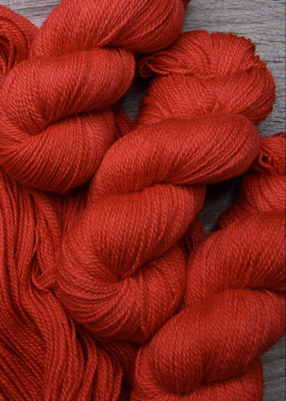 Red hand dyed wool sock yarn.