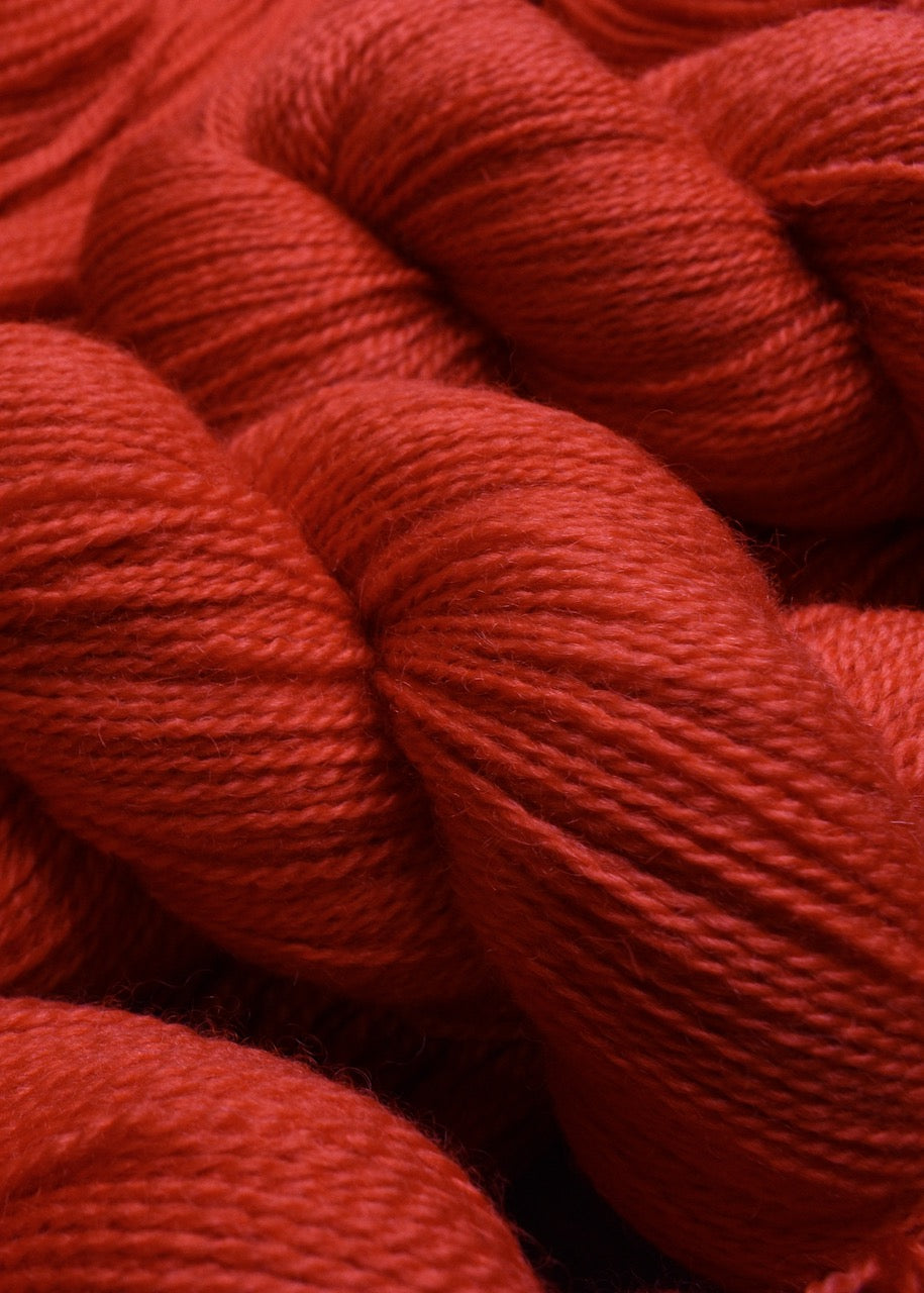 Red hand dyed wool sock yarn.