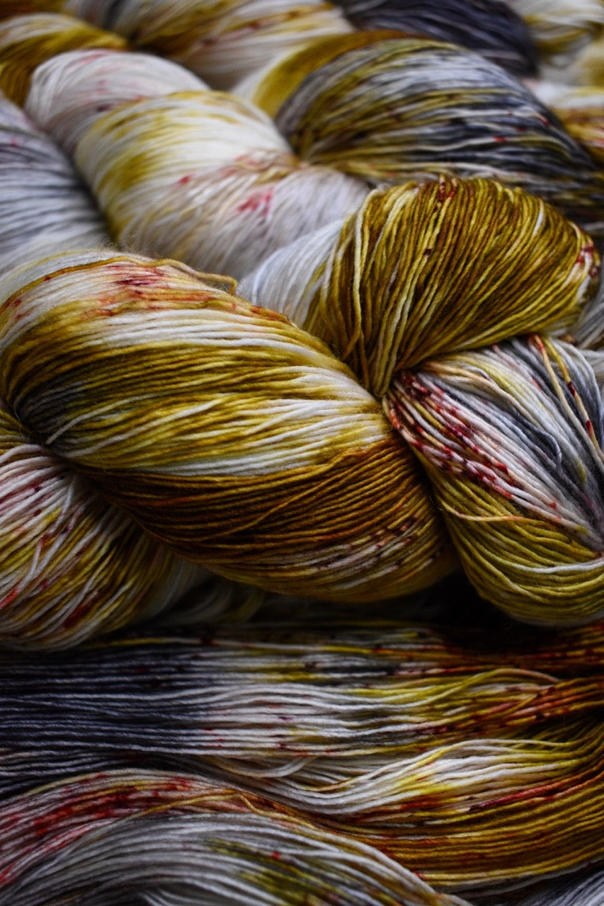 Yellow and brown speckled hand dyed  merino lace yarn.