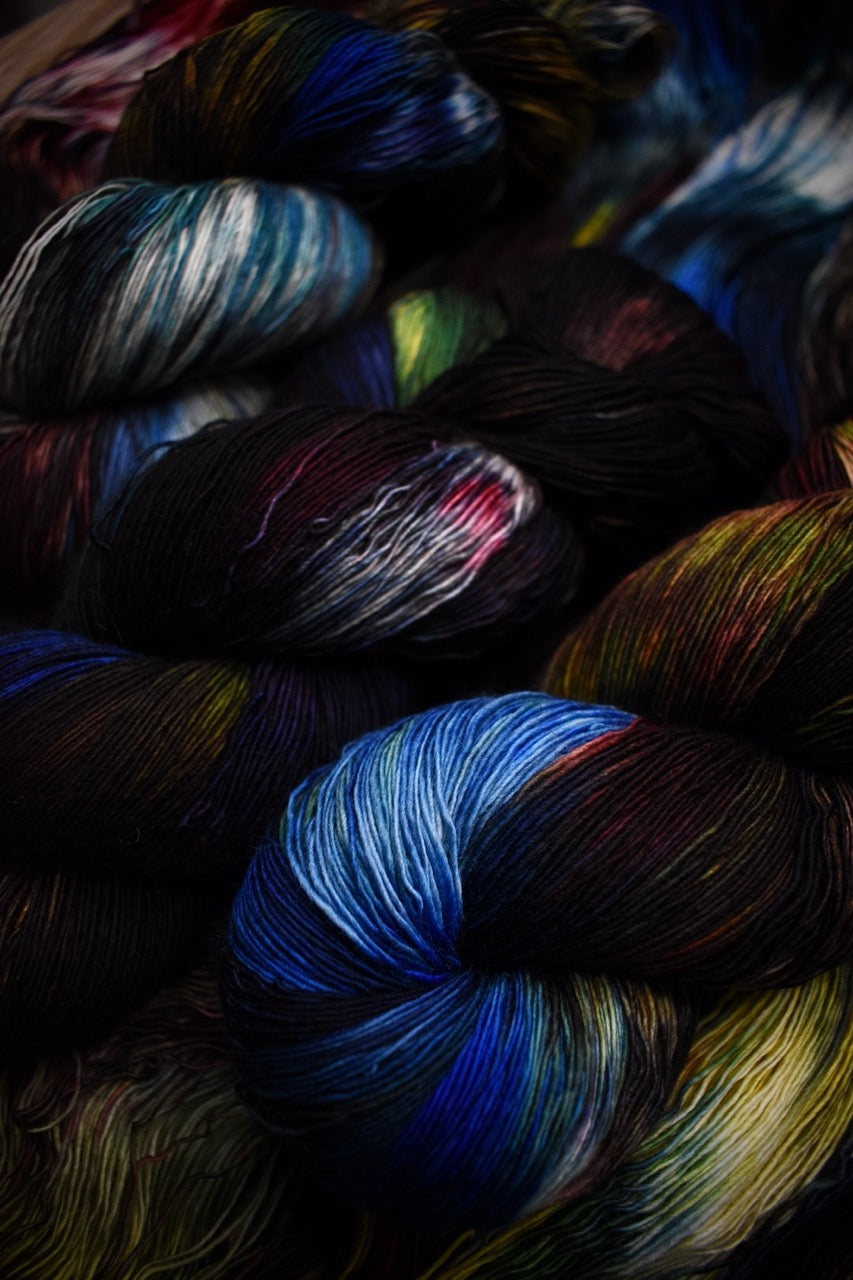 Dark rainbow colour hand dyed merino lace yarn.