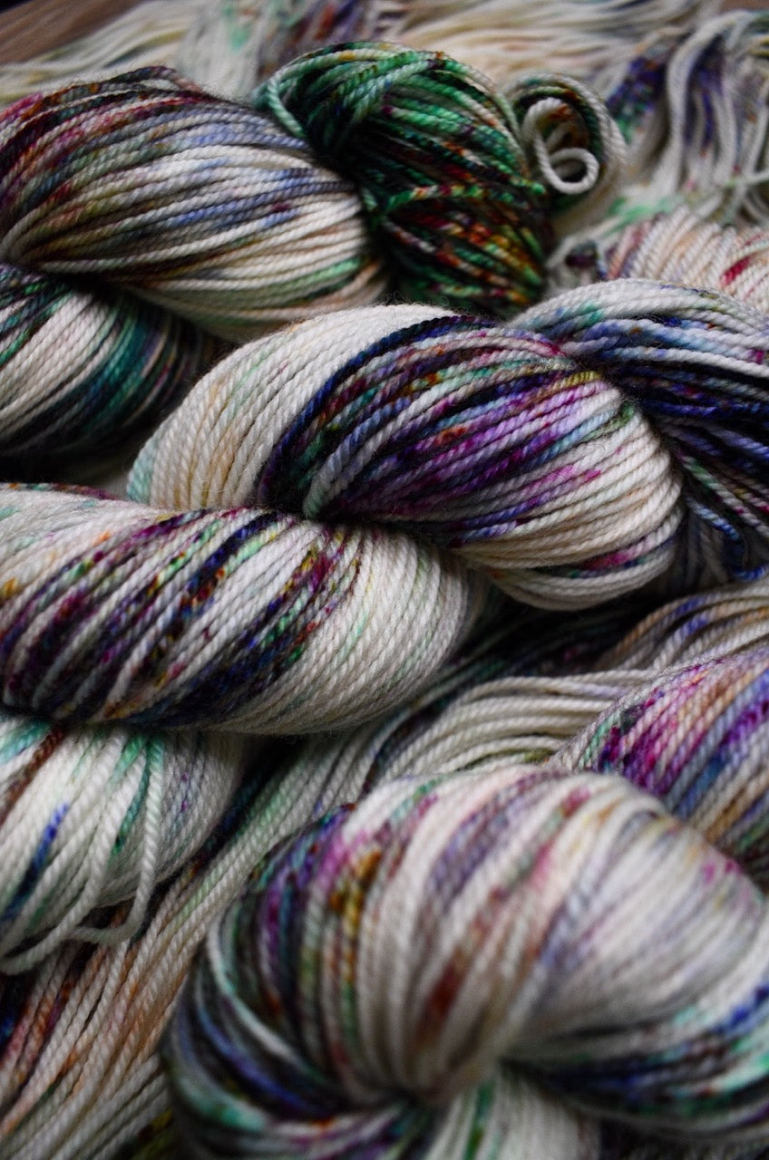 Multi colour speckles hand dyed on merino sport weight yarn.