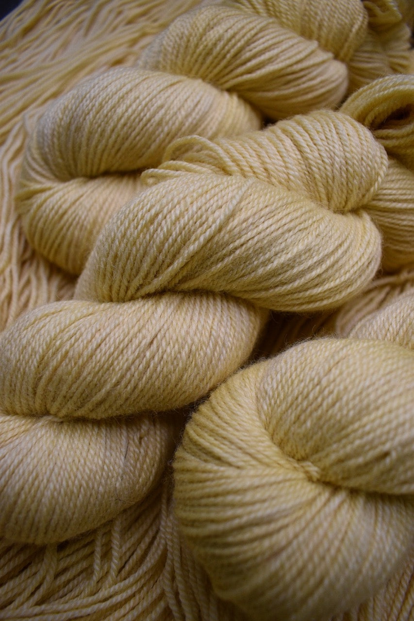 Sport weight yarn hand dyed cream colour.