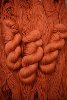 100% wool yarn hand dyed orange.