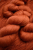 100% wool yarn hand dyed orange.