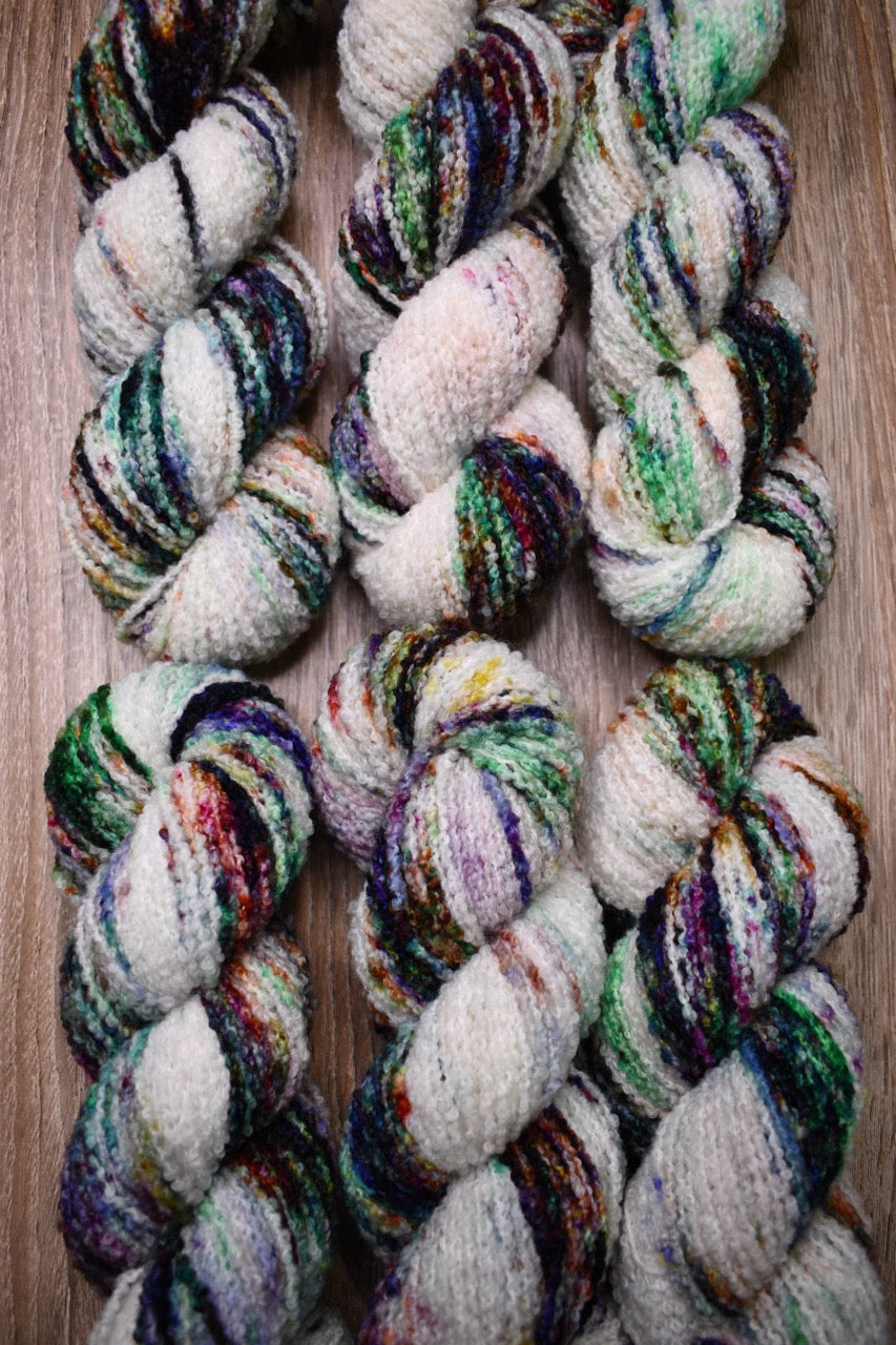 Hand dyed, merino, boucle textured yarn.