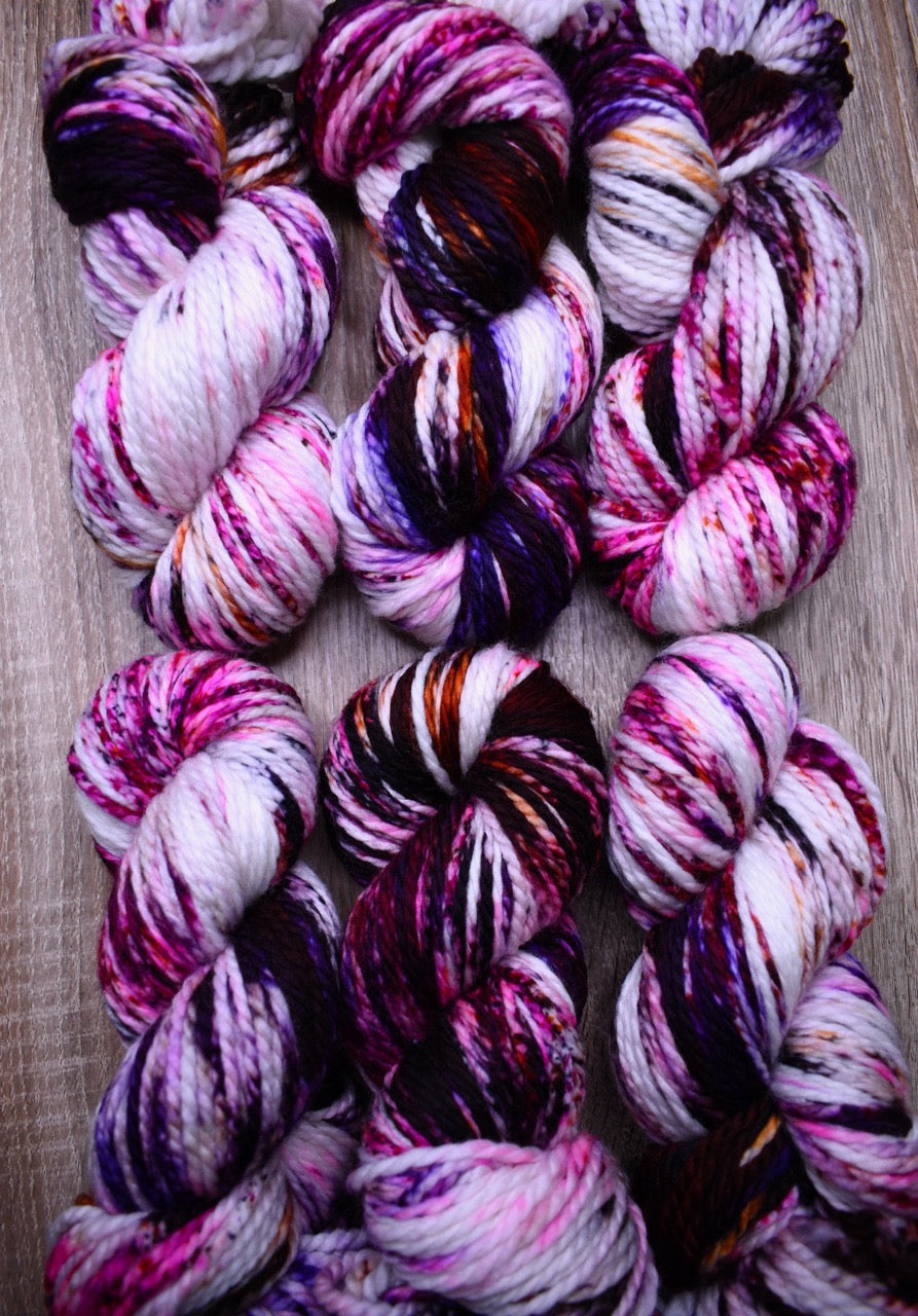 Hand dyed bulky merino wool yarn pink orange purple.