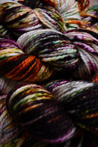 Orange green purple speckled hand dyed merino bulky weight yarn.
