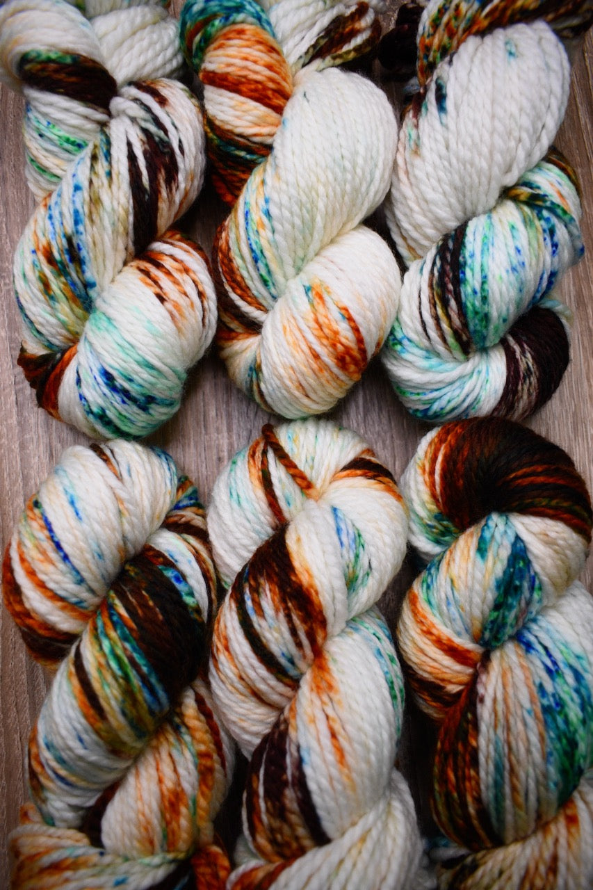 Hand dyed speckled bulky merino yarn.