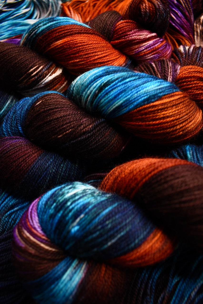 Hand dyed merino yarn blue purple orange.