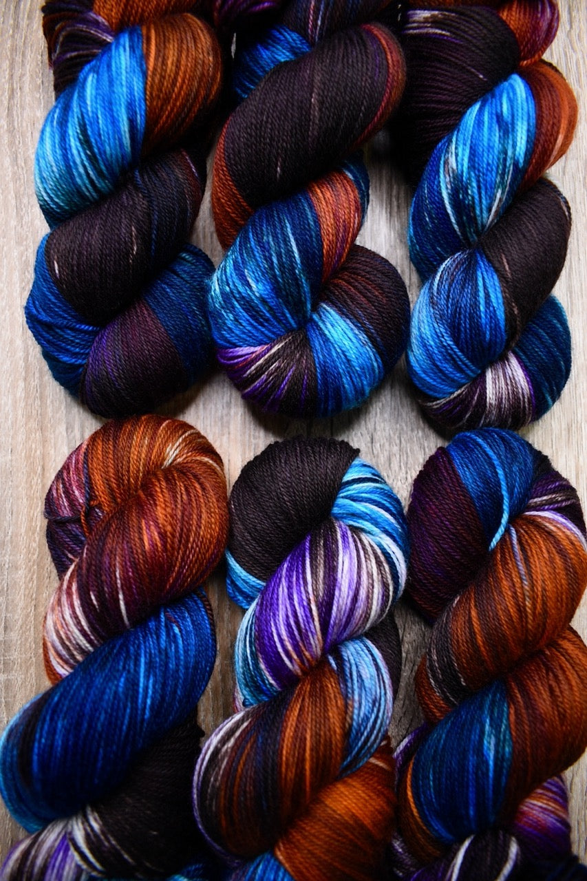 Hand dyed merino yarn blue purple orange.