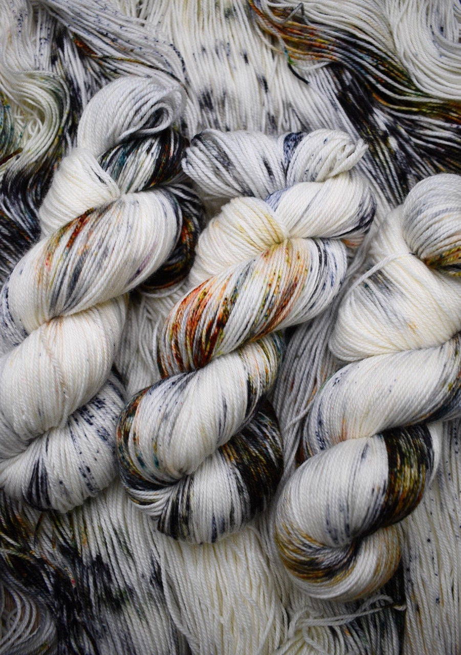 Speckled neutral gray colour hand dyed merino sock yarn.