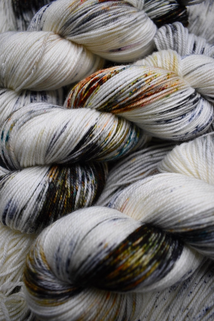 Speckled neutral gray colour hand dyed merino sock yarn.