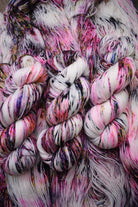 Pink speckled hand dyed merino sock yarn.