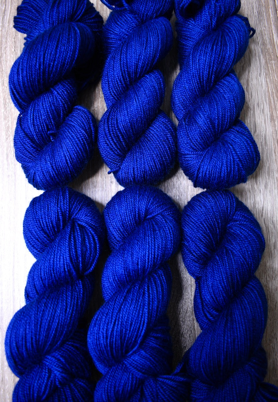 Hand dyed wool yarn bright blue.
