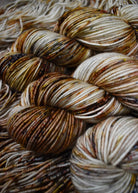 Gold brown speckles hand dyed worsted weight merino yarn.