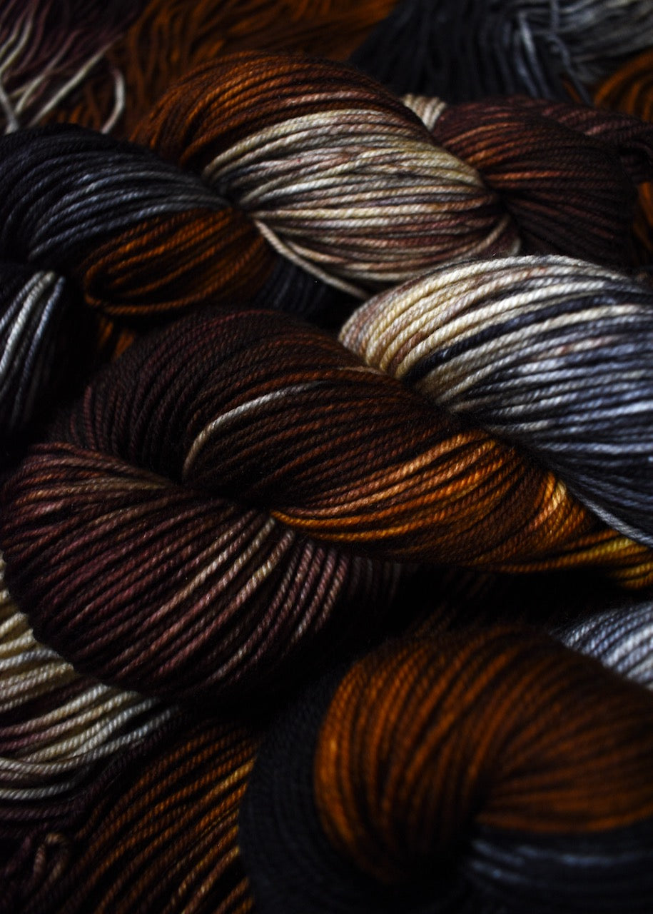 Hand dyed worsted merino yarn brown black and gray.