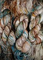 Blue and brown speckled hand dyed merino worsted yarn.