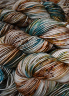 Blue and brown speckled hand dyed merino worsted yarn.