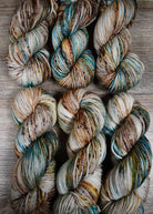 Blue and brown speckled hand dyed merino worsted yarn.