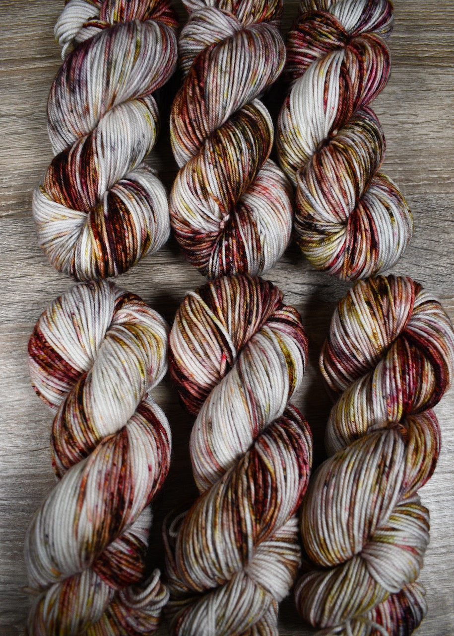 Hand dyed merino yarn pink and gray speckled.