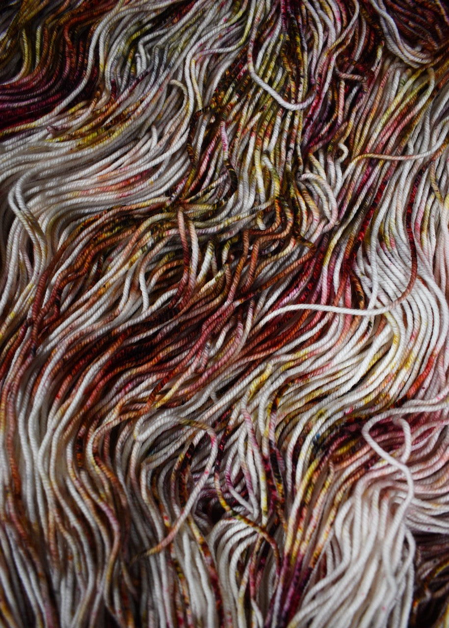 Hand dyed merino yarn pink and gray speckled.