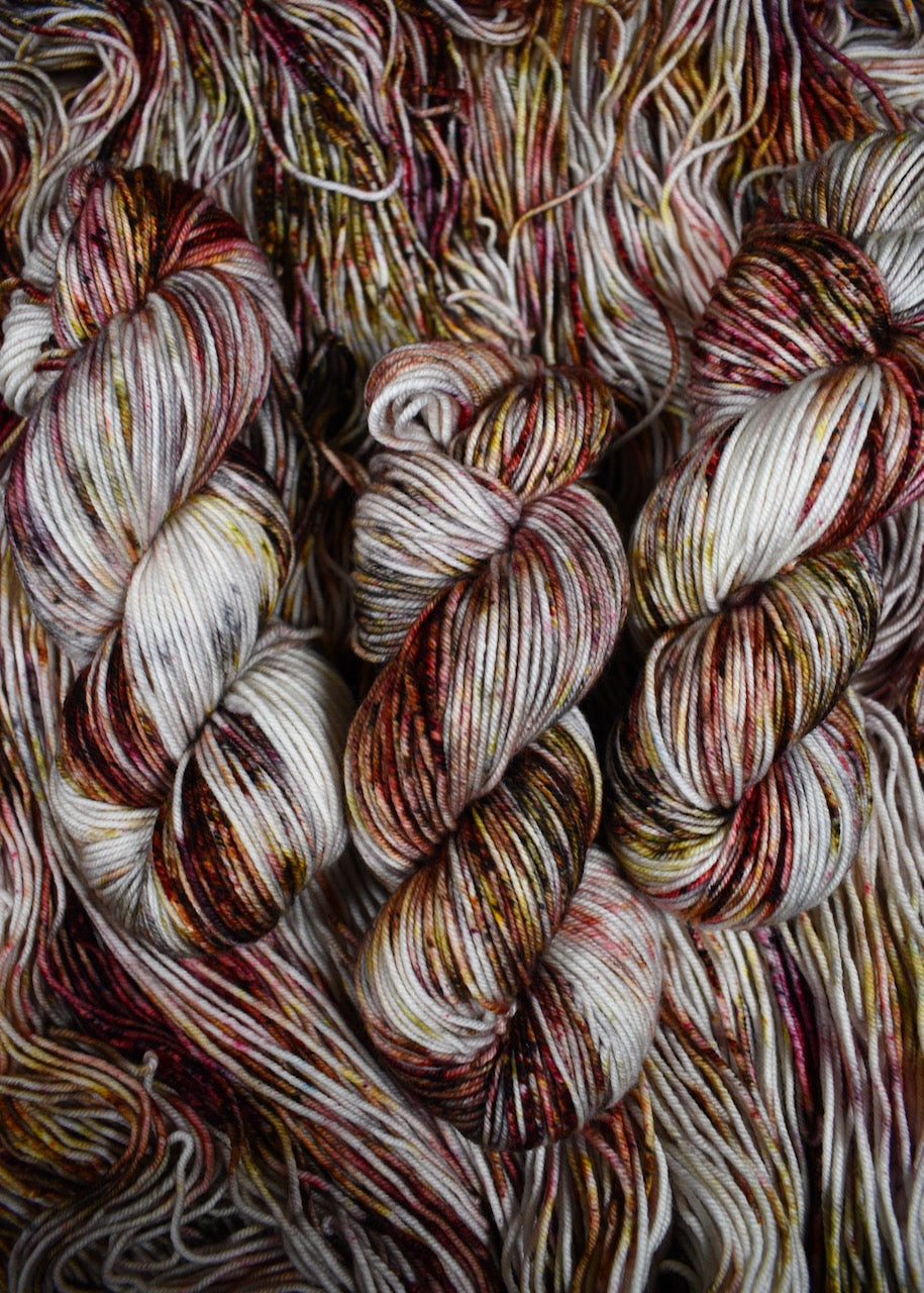 Hand dyed merino yarn pink and gray speckled.