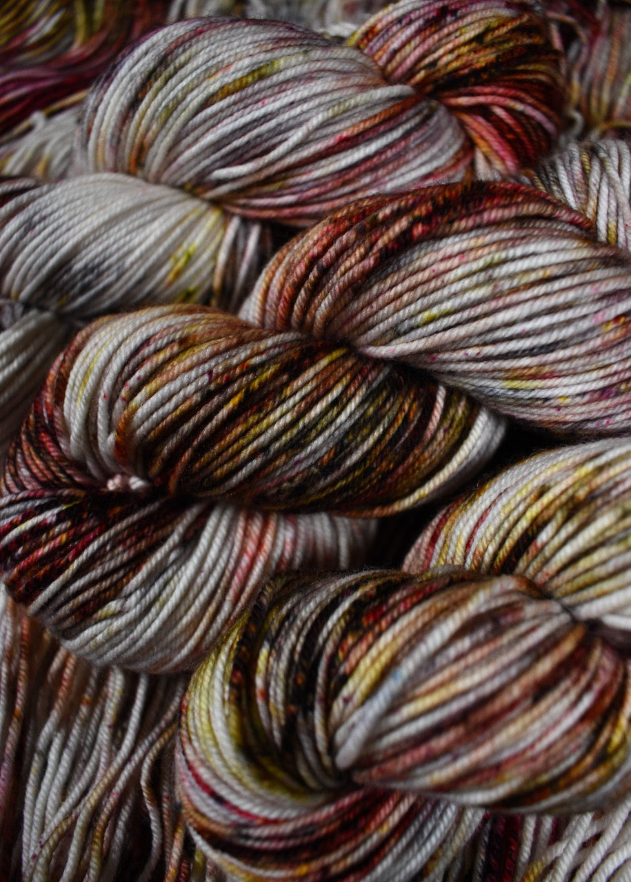 Hand dyed merino yarn pink and gray speckled.