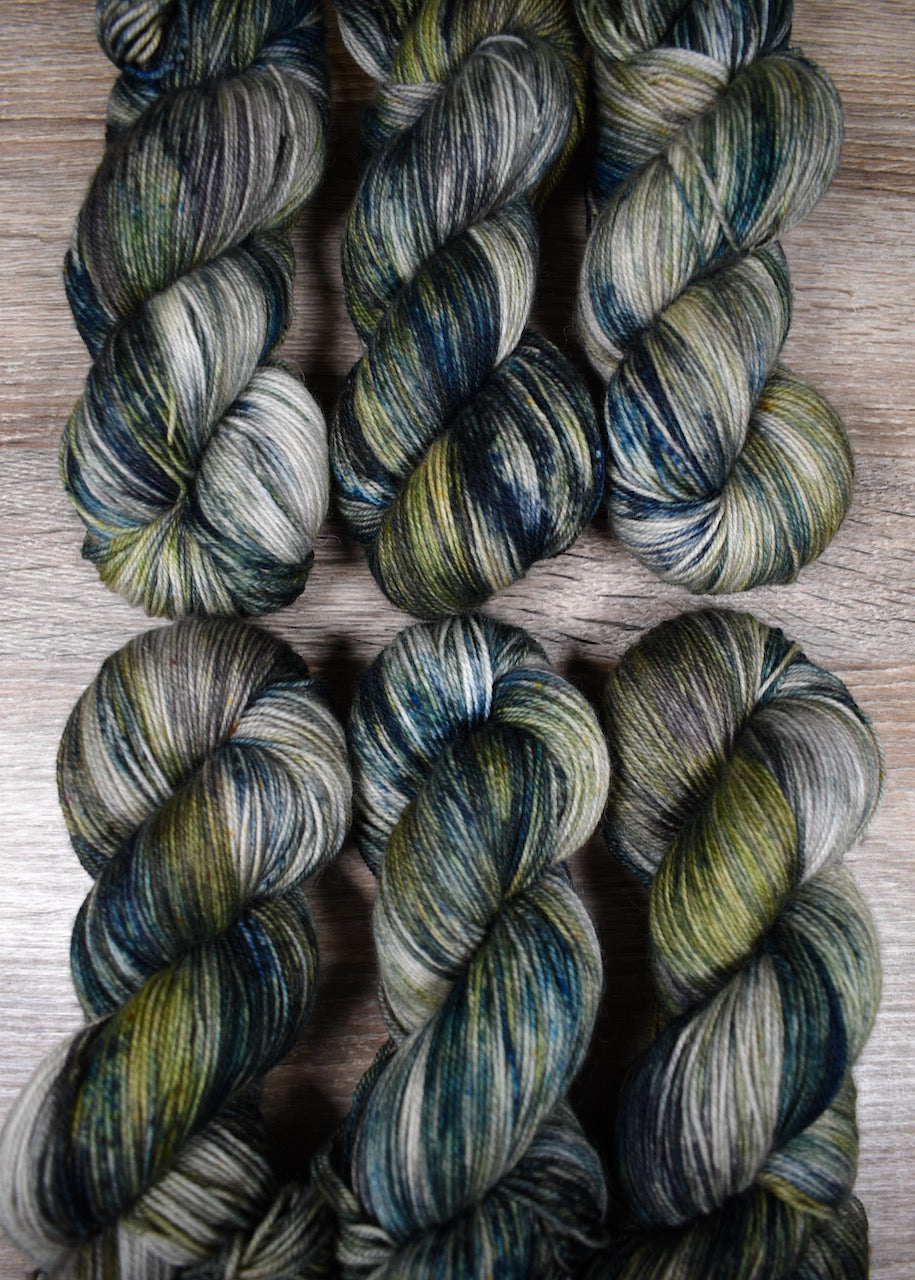 Light gray and green speckled wool sock yarn hand dyed.