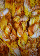 Yellow speckled hand dyed wool sock yarn.