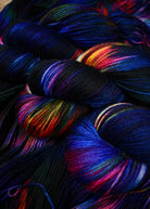 Blue red yellow and green hand dyed wool sock yarn.