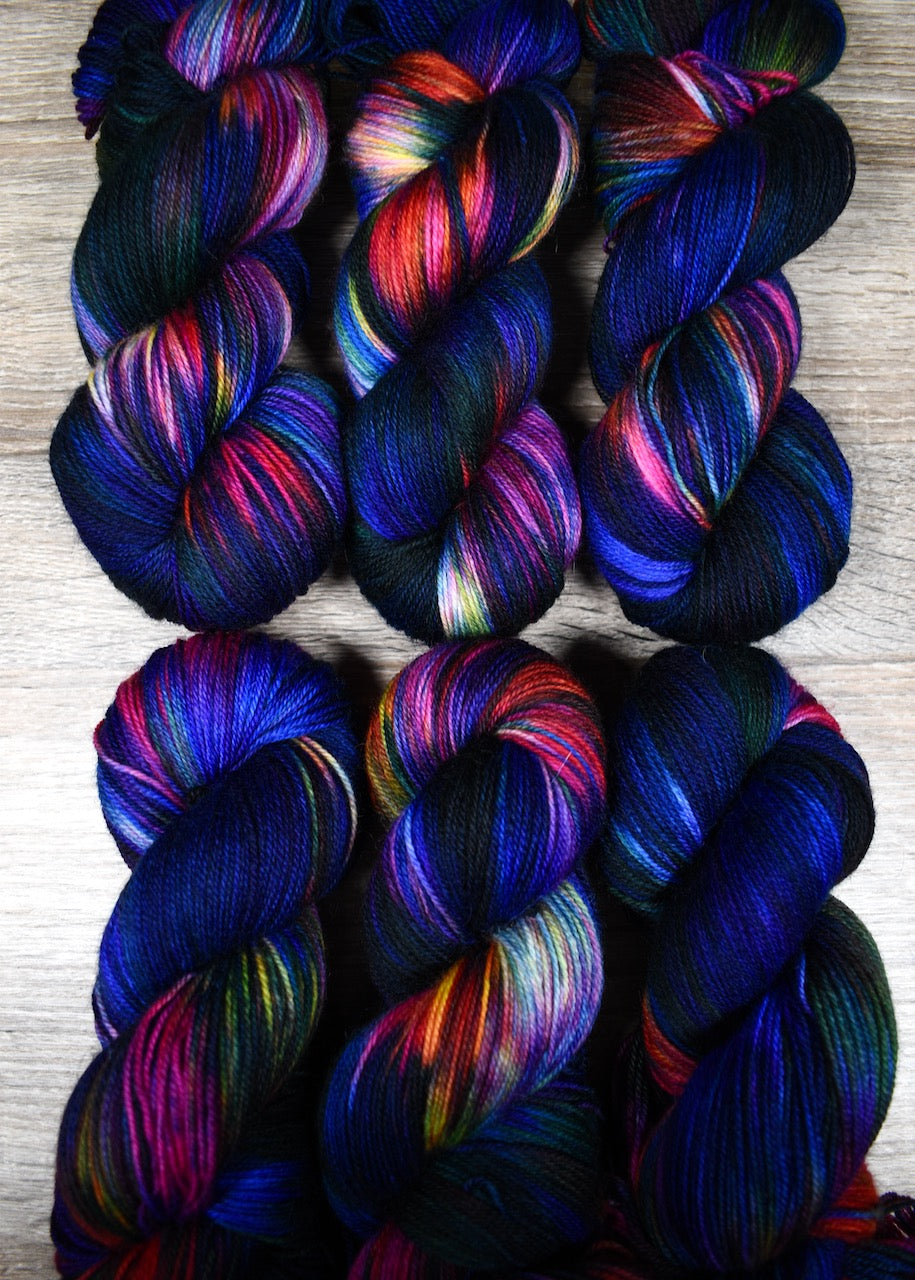 Blue red yellow and green hand dyed wool sock yarn.