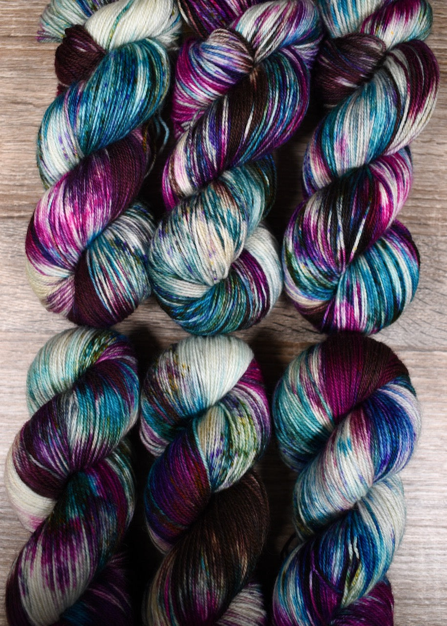 Hand dyed bfl wool sock yarn in pink and blue colours.