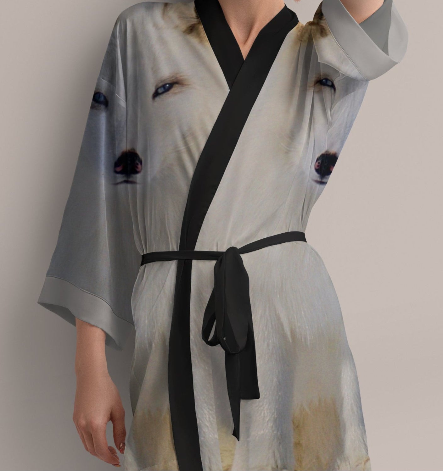 Woman wearing a light gray kimono-style robe with arctic fox print