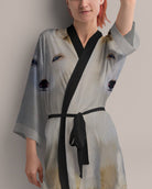 Woman wearing a light gray kimono-style robe with arctic fox print