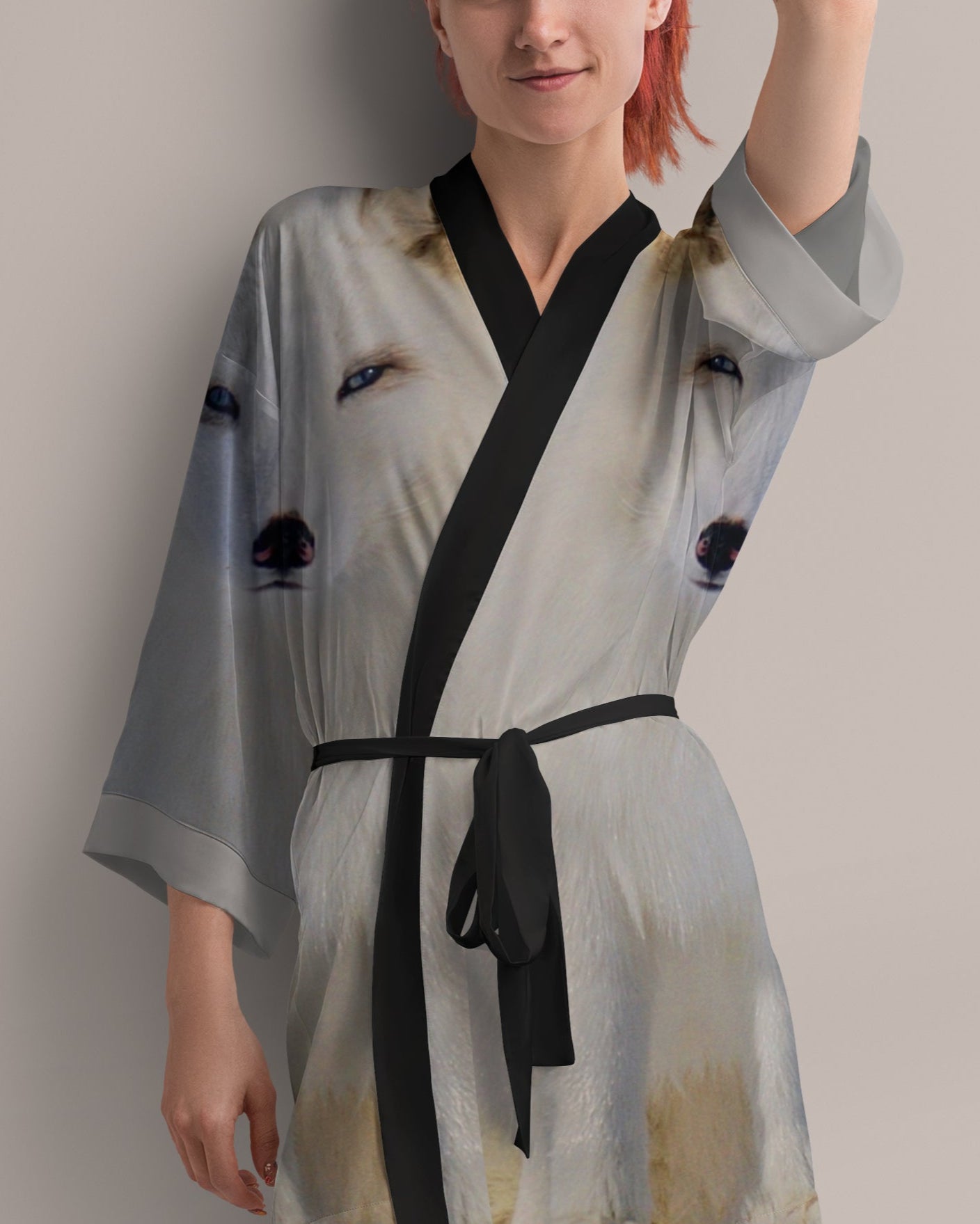 Woman wearing a light gray kimono-style robe with arctic fox print
