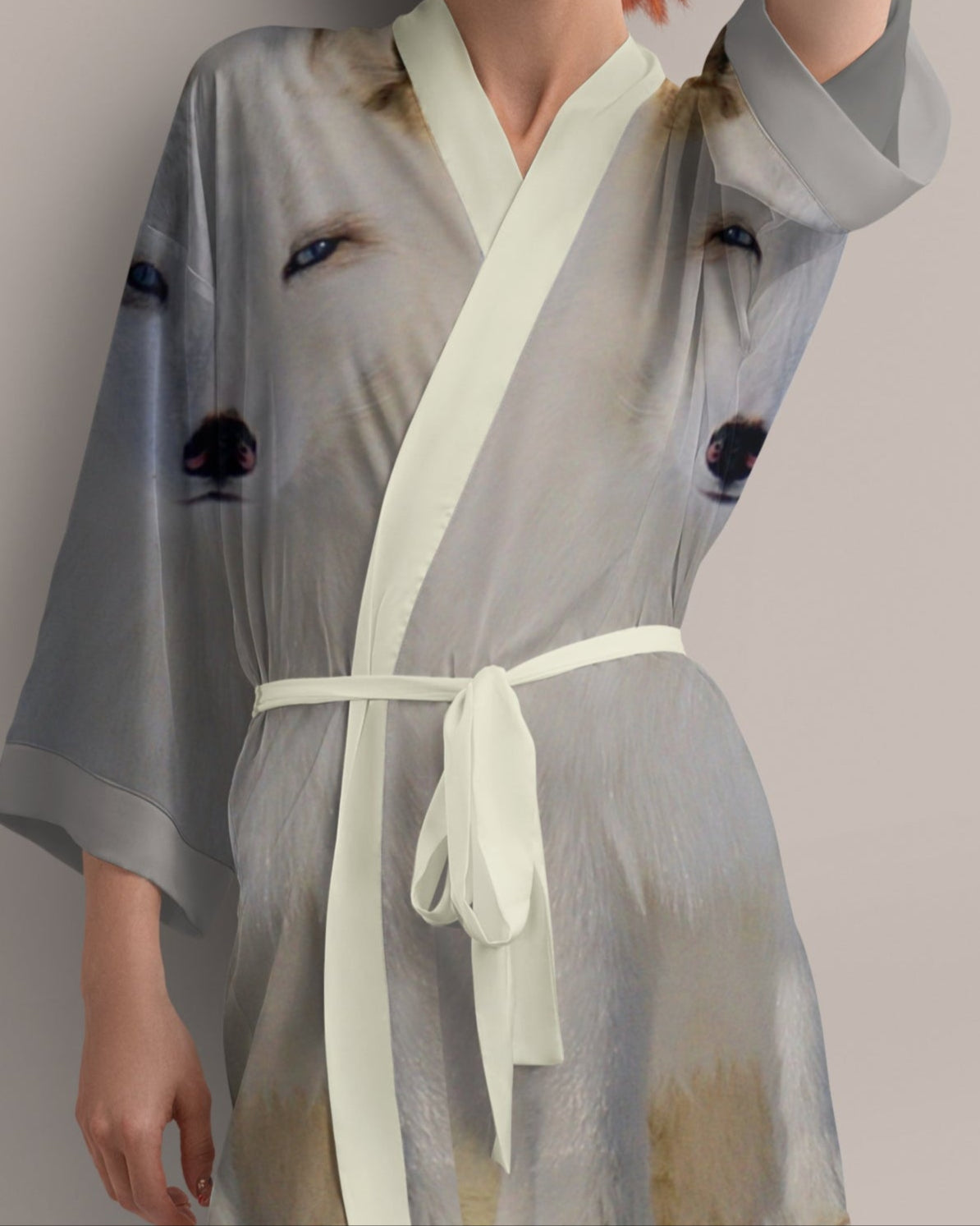 Woman wearing a light gray kimono-style garment with photo print of arctic fox