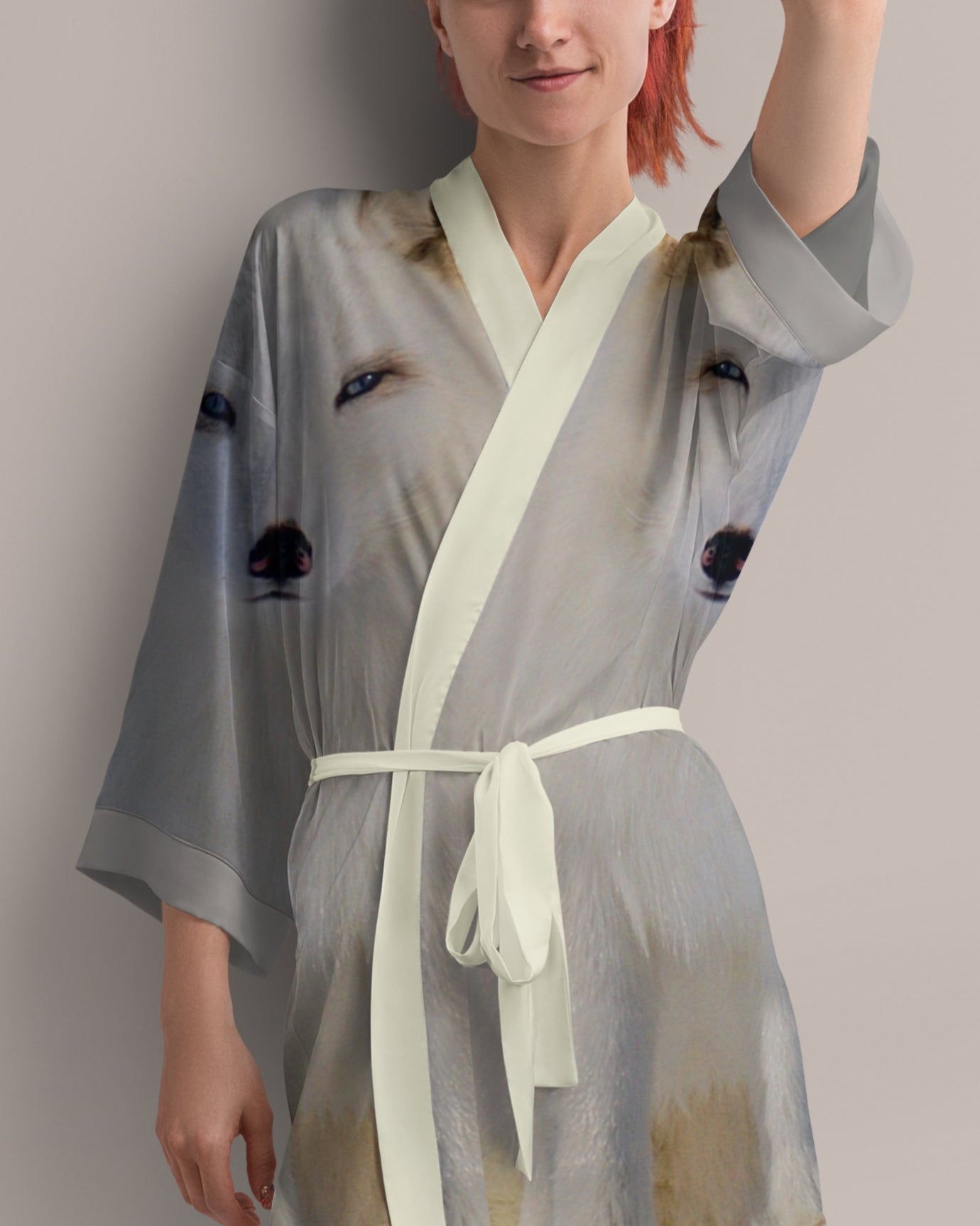 Woman wearing a light gray kimono-style garment with photo print of arctic fox
