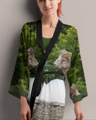 Woman wearing a kimono with a nature print of bighorn sheep on a plain background