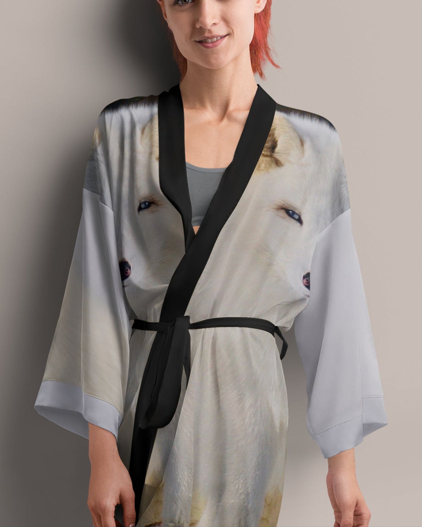 Woman wearing a light coloured kimono with a print of an arctic fox