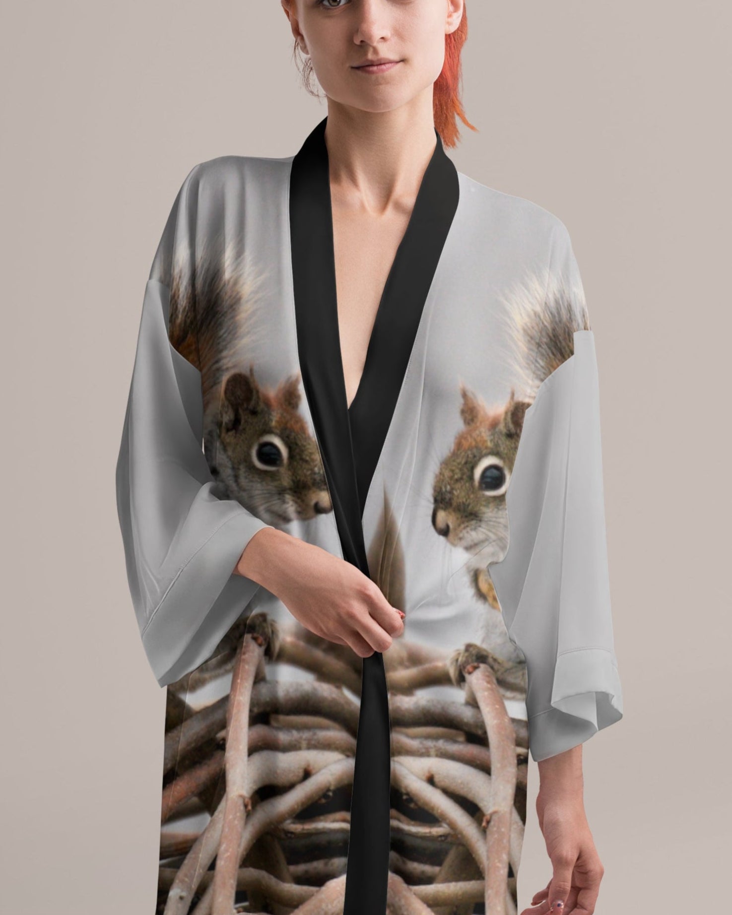 Woman wearing a kimono-style garment with squirrel print on a plain background