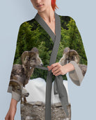 Woman wearing a silk robe with animal print design.