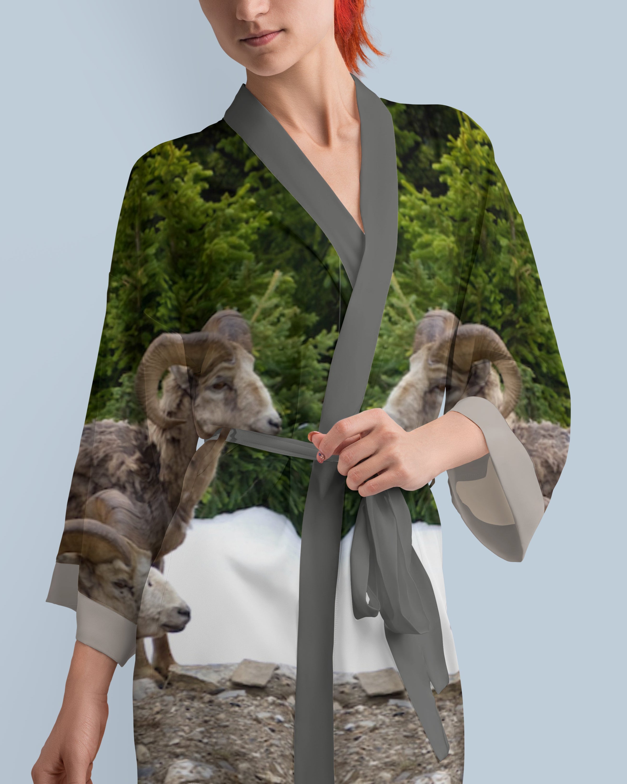 Woman wearing a silk robe with animal print design.
