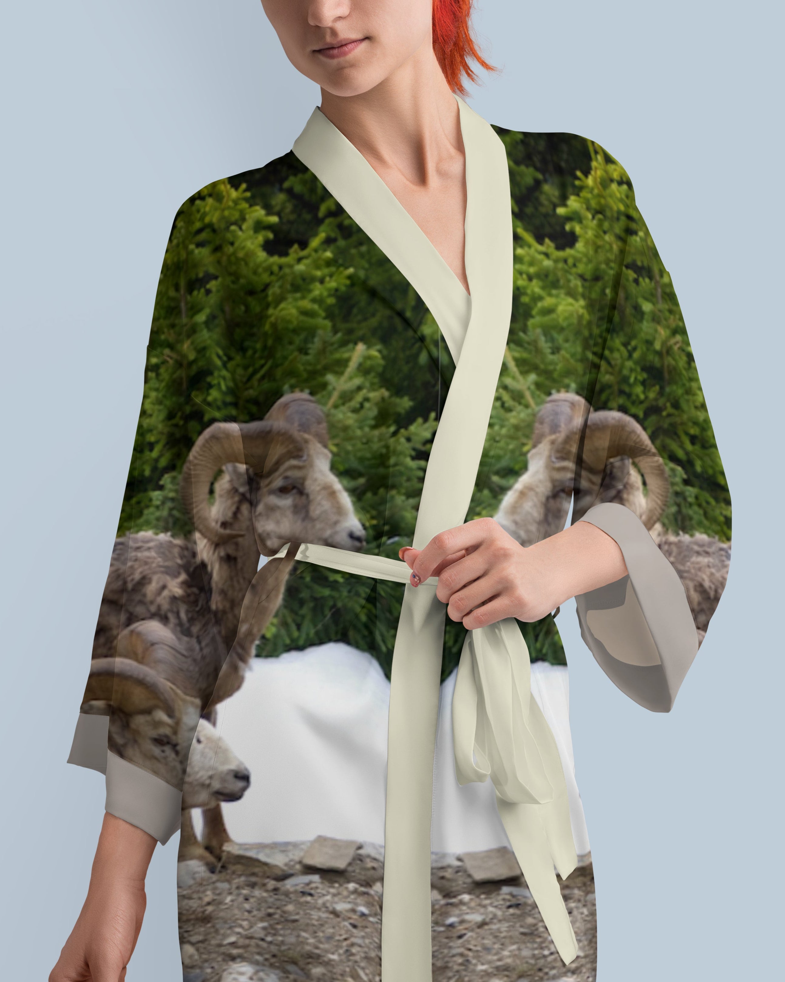 Woman wearing a kimono-style garment with a nature-themed design featuring animals.