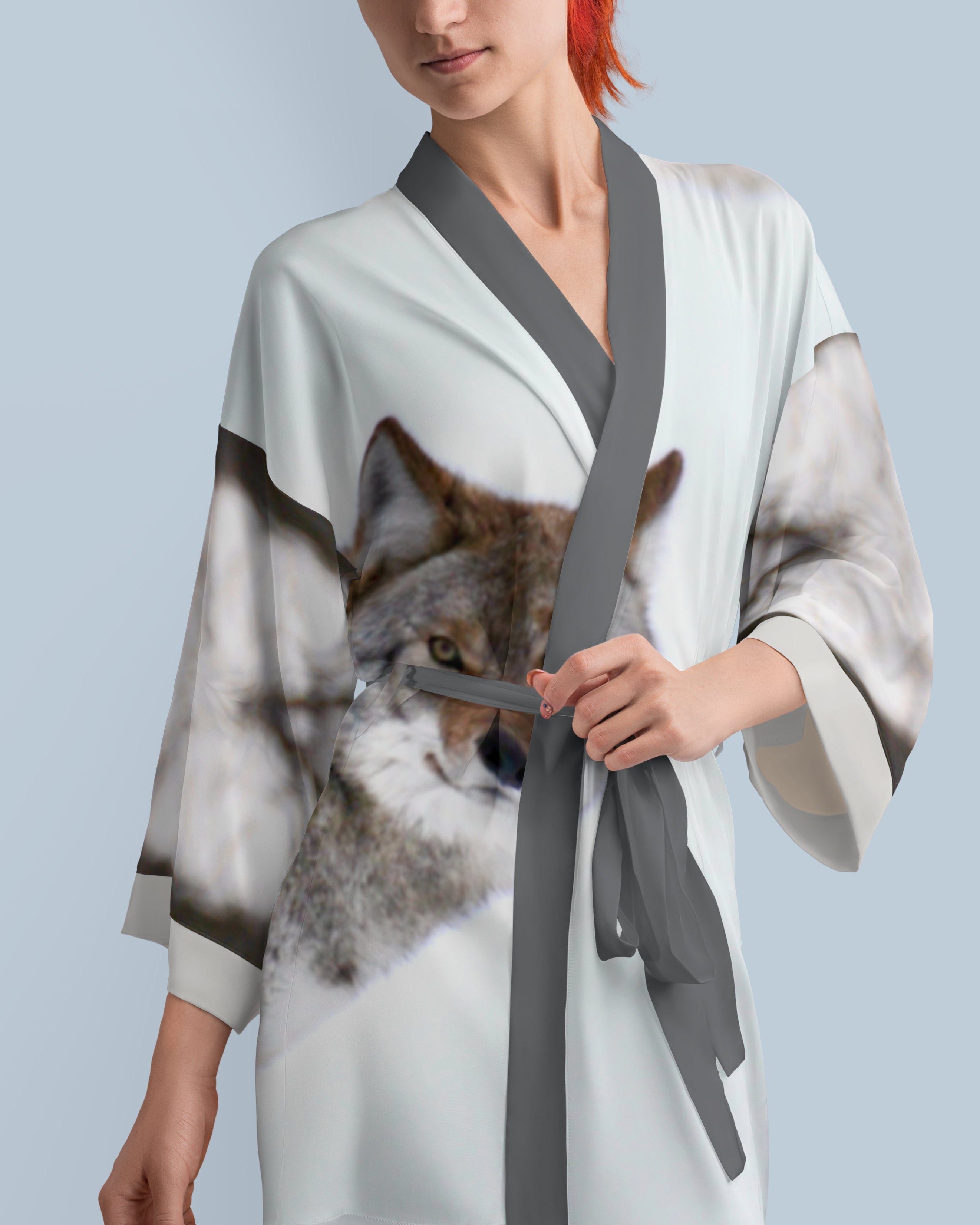 Woman wearing a kimono-style robe printed with a coyote photograph