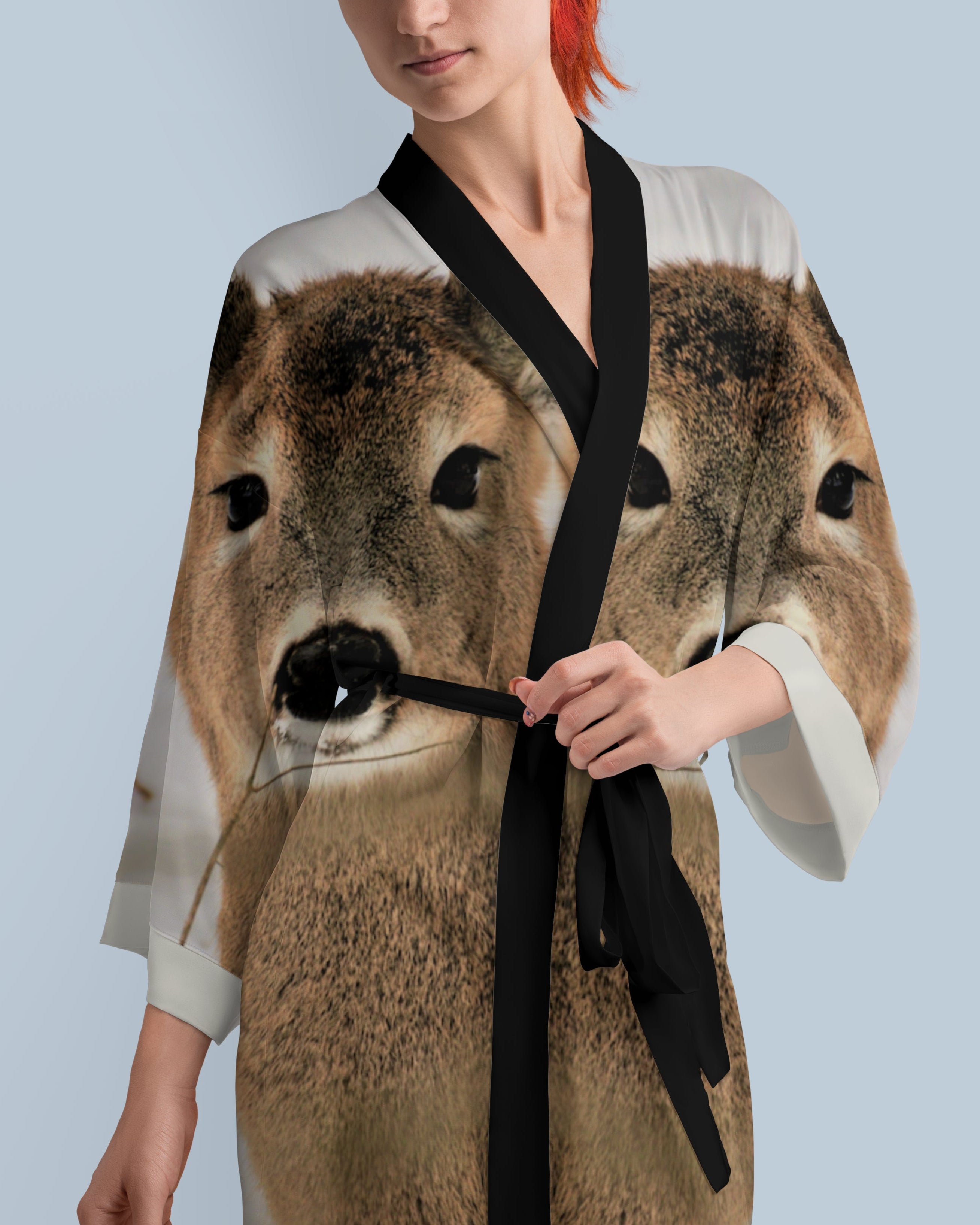 Woman wearing a dress with a deer print against a light blue background