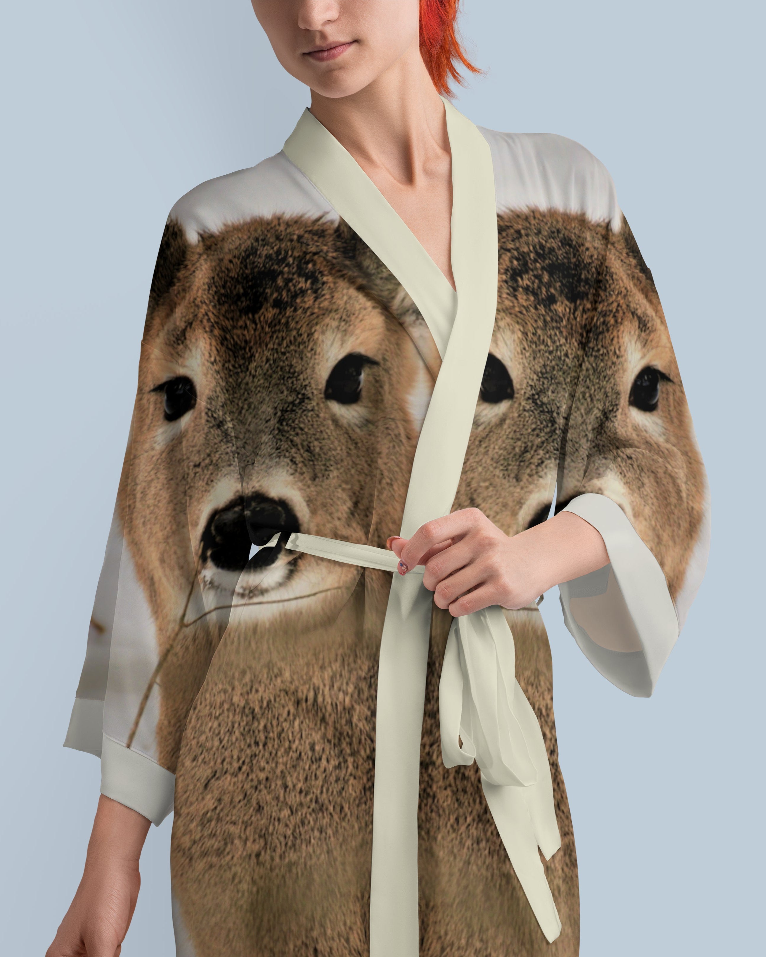 Person wearing a kimono with a deer design on a light blue background