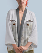 Woman wearing a light gray kimono with snowy owl print