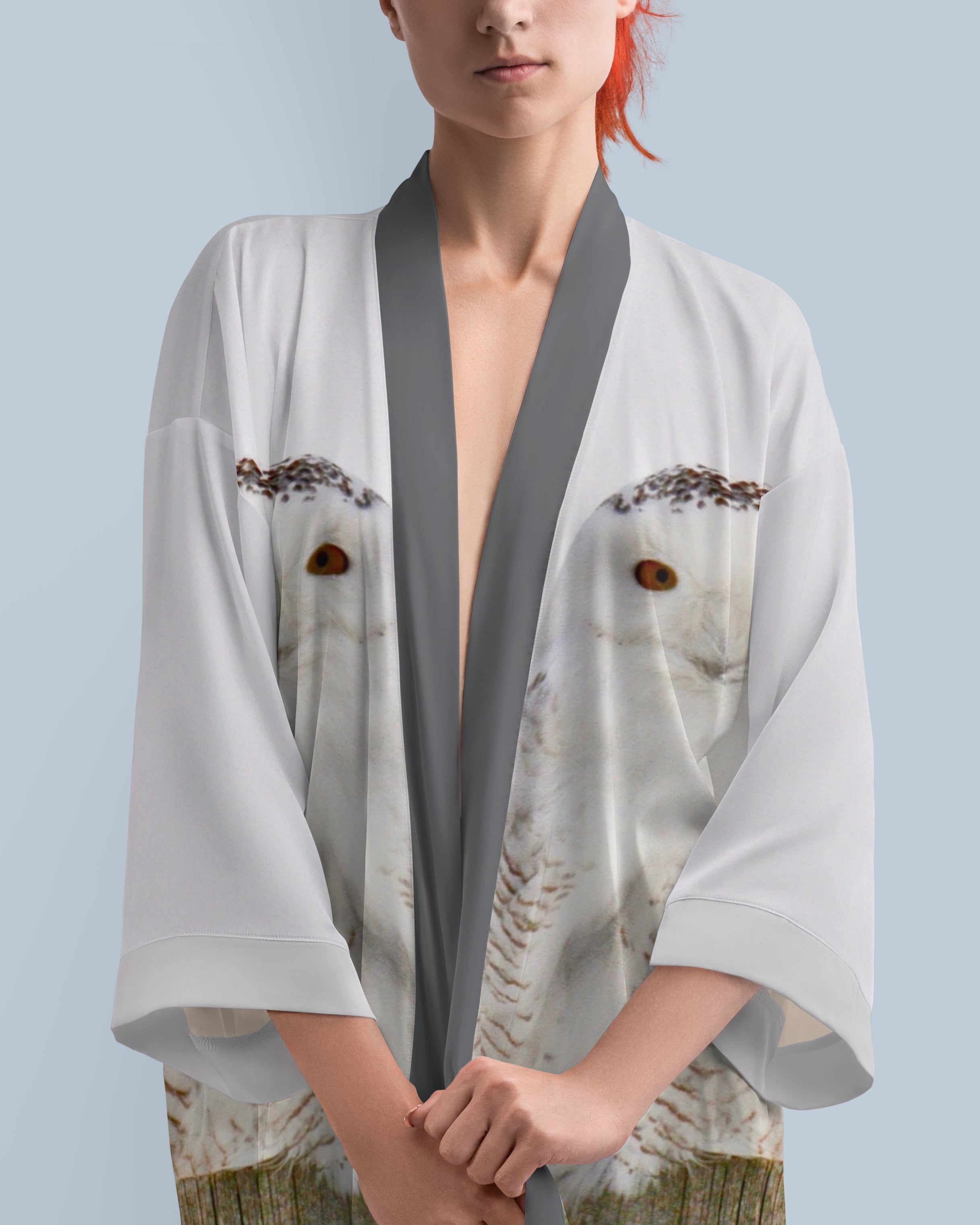 Woman wearing a light gray kimono with snowy owl print