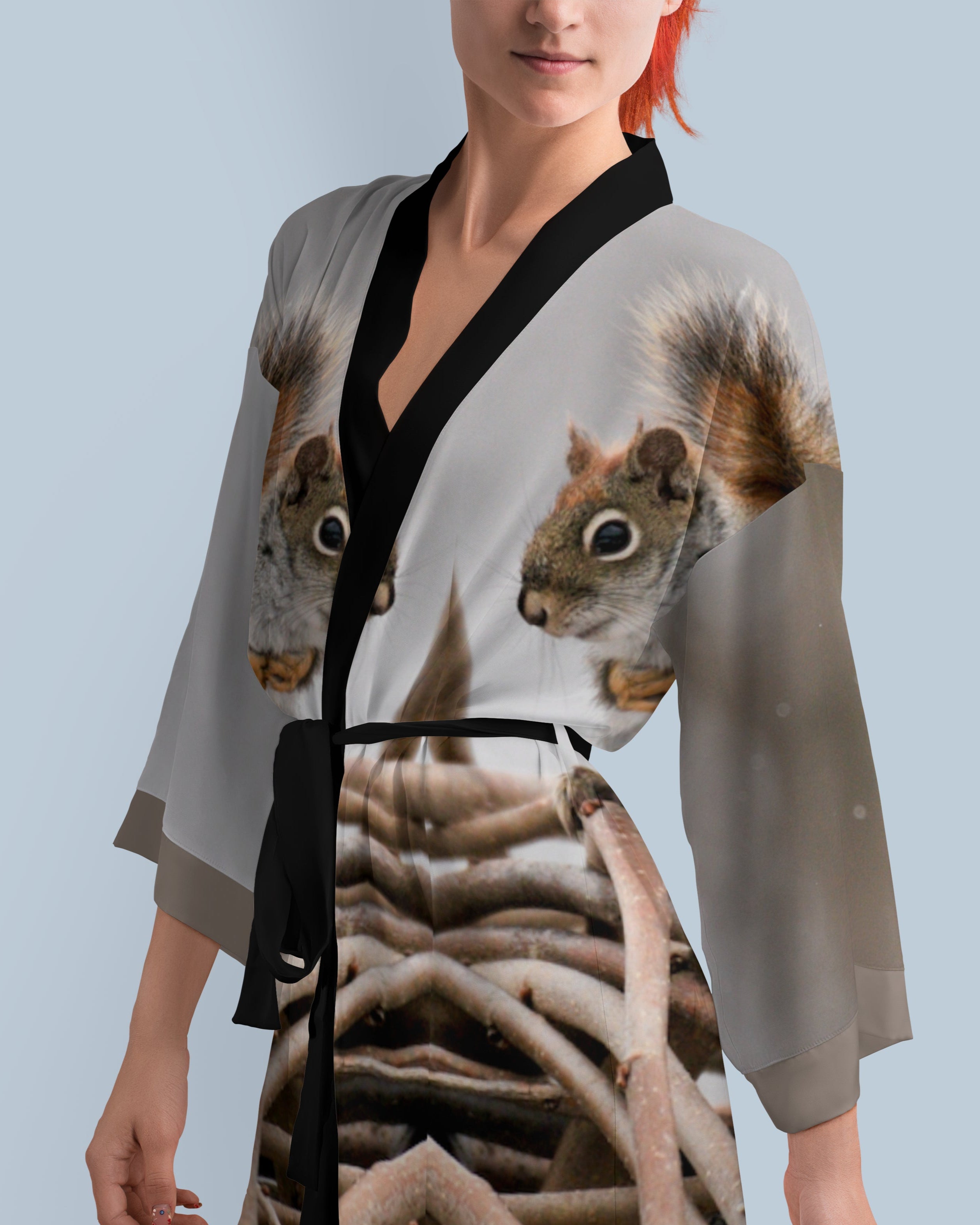 Woman wearing a kimono-style dress with a squirrel design 