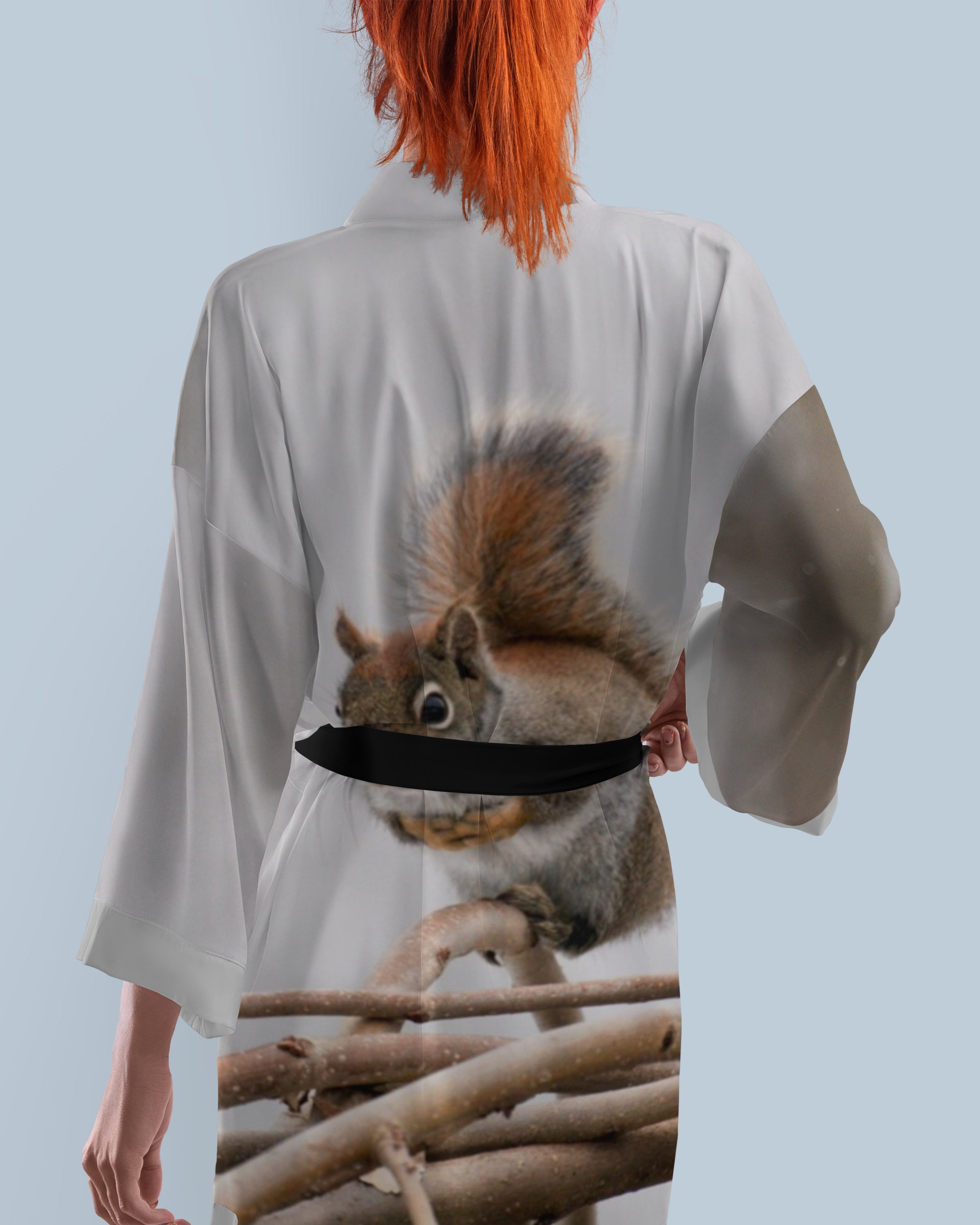 Person wearing a robe with a squirrel design on the back 